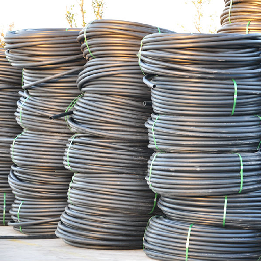 coiled black plastic pipe for irrigation and cable protection